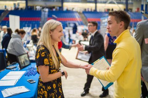 Image of Students and Employers meeting at the UNH Career and Internship Fair at the Whittemore Center