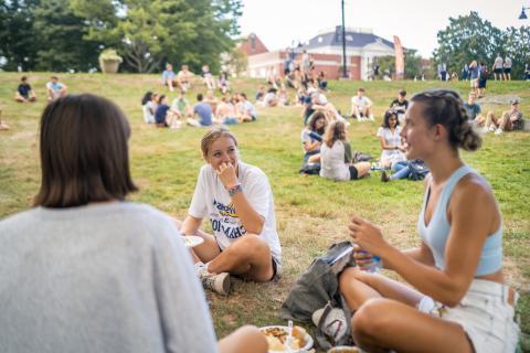 UNH students hanging out on the lawn